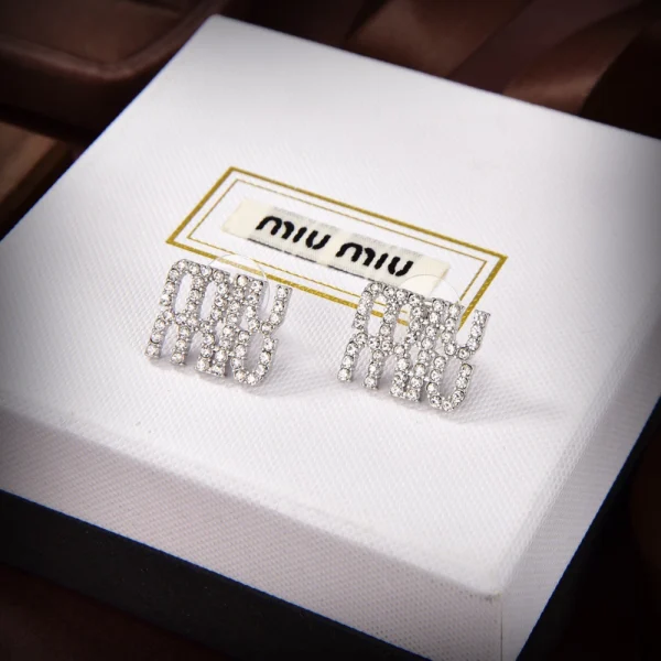 Miu Miu metal earrings with sleek polished finish and minimalist modern design