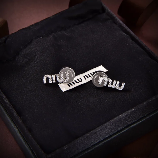 Miu Miu metal earrings with sparkling crystal accents and polished finish