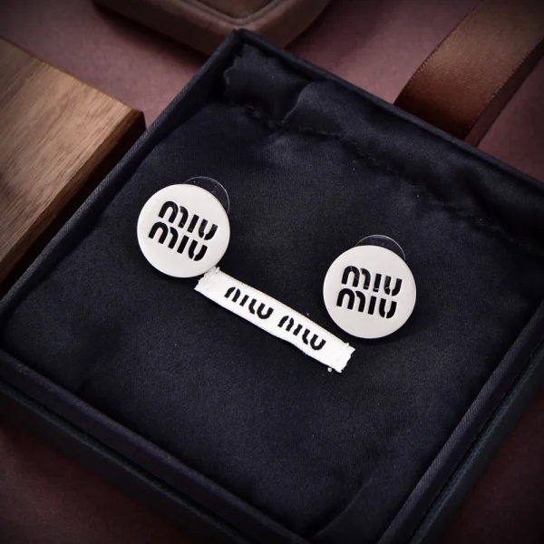 Miu Miu logo earrings featuring polished metal and signature brand lettering