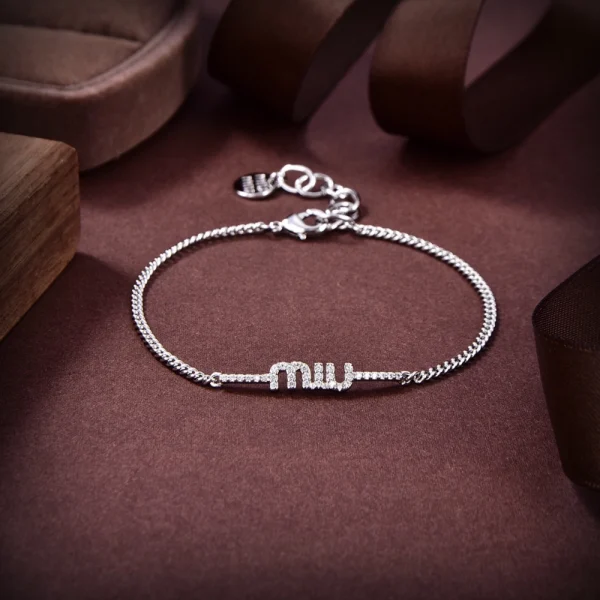 Miu Miu silver charm bracelet featuring polished finish and signature pendants