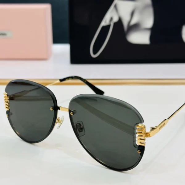 Close-up of Miu Miu sunglasses on a smooth tabletop with matching case positioned in the distance