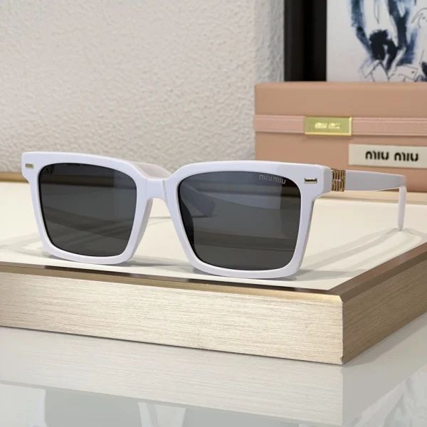 Angled view of Miu Miu sunglasses highlighting metallic logo on the side