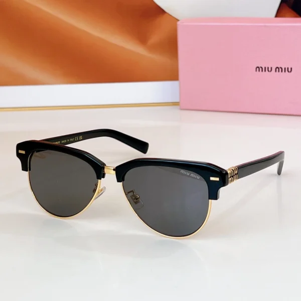Miu Miu sunglasses resting on a tabletop with branded case blurred in the background