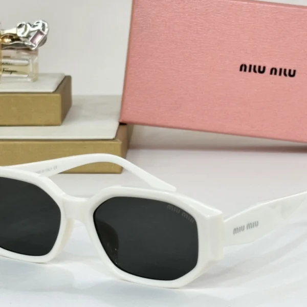 Model wearing Miu Miu sunglasses styled with neutral tones for a chic street look