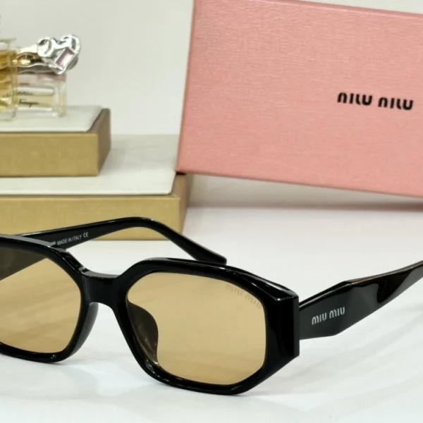 Close-up of Miu Miu sunglasses showing thick acetate frame and embossed logo