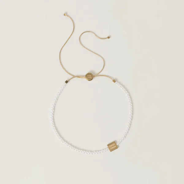 Miu Miu metal choker featuring artificial pearls and elegant gold-tone finish