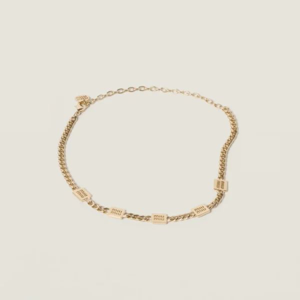 Elegant Miu Miu metal necklace styled with contemporary fashion outfit