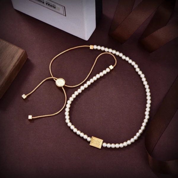 Miu Miu pearl and metal choker featuring elegant design and signature charm