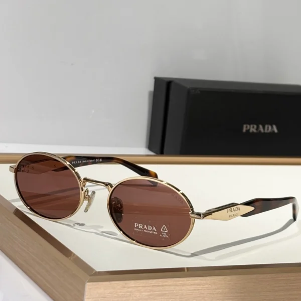 Front view of Prada Eyewear Collection sunglasses in tortoiseshell pattern with soft gradient lenses