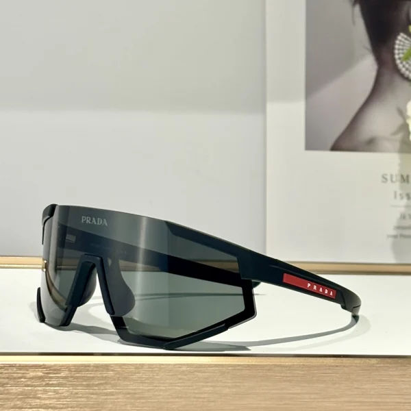 Close-up of Prada Impavid sunglasses from Linea Rossa collection, highlighting bold lens curve and sporty temples