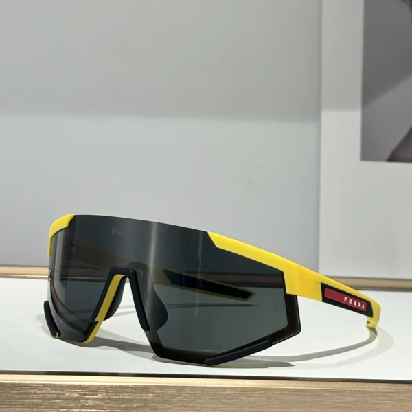 Prada Linea Rossa Impavid sunglasses resting on textured surface with high-tech aesthetic, emphasizing performance style