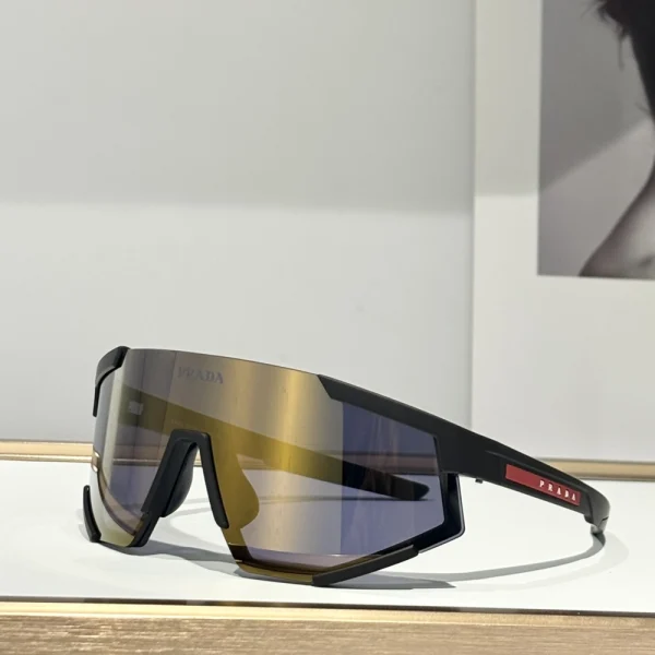 Futuristic Prada Impavid sunglasses from Linea Rossa, placed next to minimalist tech gear for a modern active look