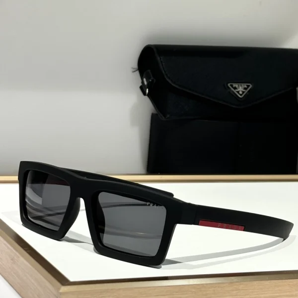 Detail shot of Prada Impavid sunglasses featuring high-performance lens technology and subtle red Prada Linea Rossa logo