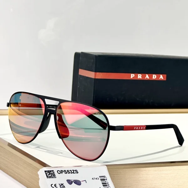 Prada Linea Rossa sunglasses featuring wraparound frame and bold red stripe logo, placed on a white surface with case nearby