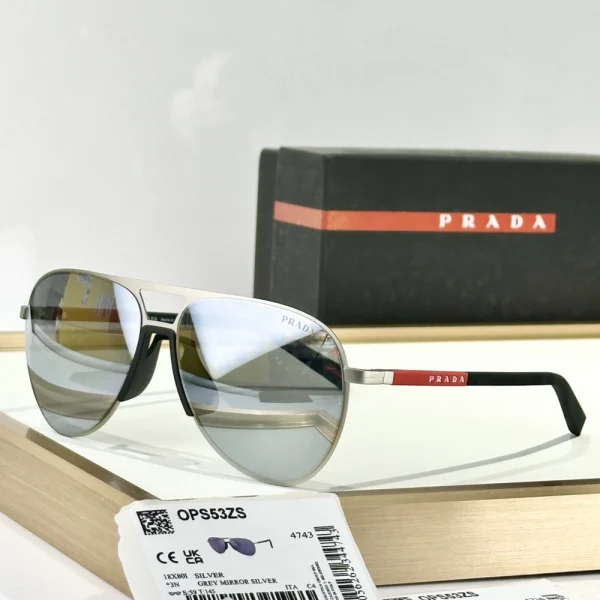 Close-up of Prada Linea Rossa sunglasses with reflective lenses and matte black frame, highlighting sporty design