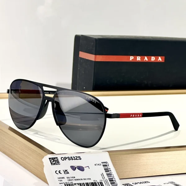 Front view of Prada Linea Rossa sunglasses with signature red logo on the temples, resting on minimal background