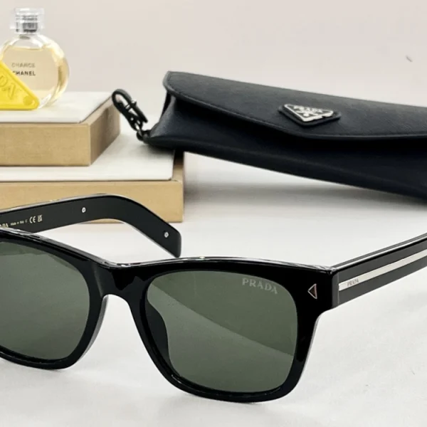 Prada sunglasses featuring the iconic metal plaque on wide temples, sleek black frame with grey lenses