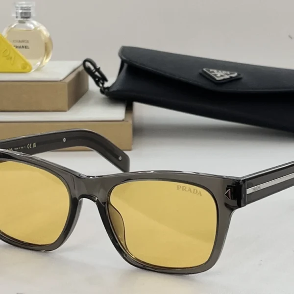Prada sunglasses styled with luxury accessories, with metal plaque on temple reflecting light in focus