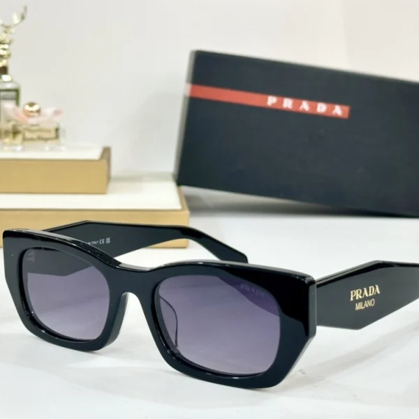 Prada sunglasses placed diagonally with lighting highlighting the iconic logo and temple structure