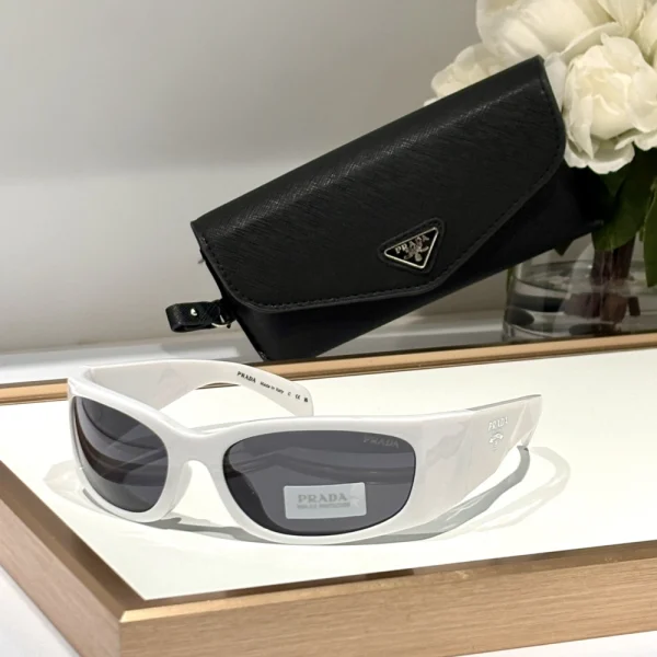 Front view of Prada Symbole sunglasses featuring square lenses and sharp lines, styled with neutral background
