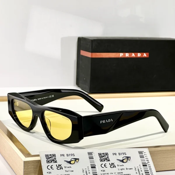 Close-up of Prada Symbole sunglasses emphasizing the sculpted temples and iconic Prada logo plaque