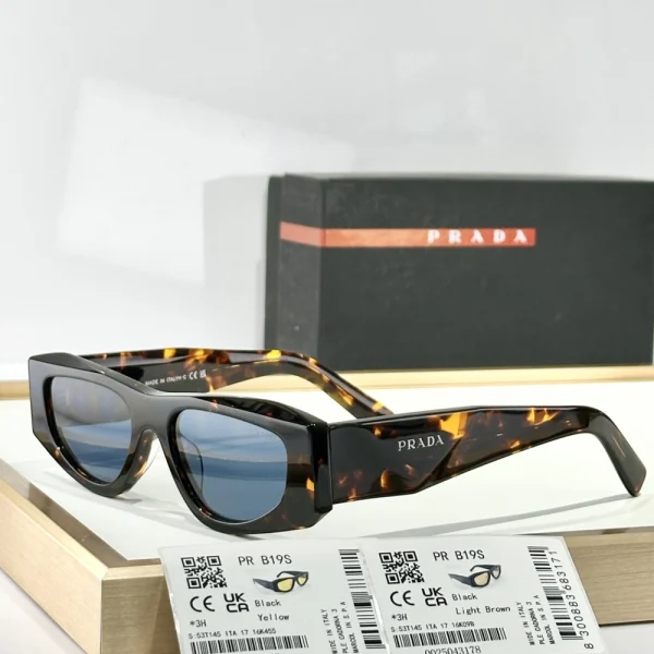 Side view of Prada Symbole sunglasses showing the architectural lines and gold triangle logo on the temple