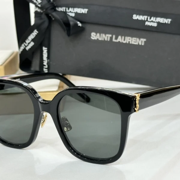 Front-facing Saint Laurent SL M40 sunglasses with dark grey lenses and subtle YSL monogram on arms