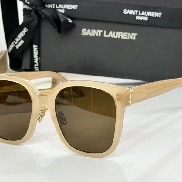 High-fashion Saint Laurent Monogram SL M40 sunglasses styled with minimalist jewelry and neutral accessories