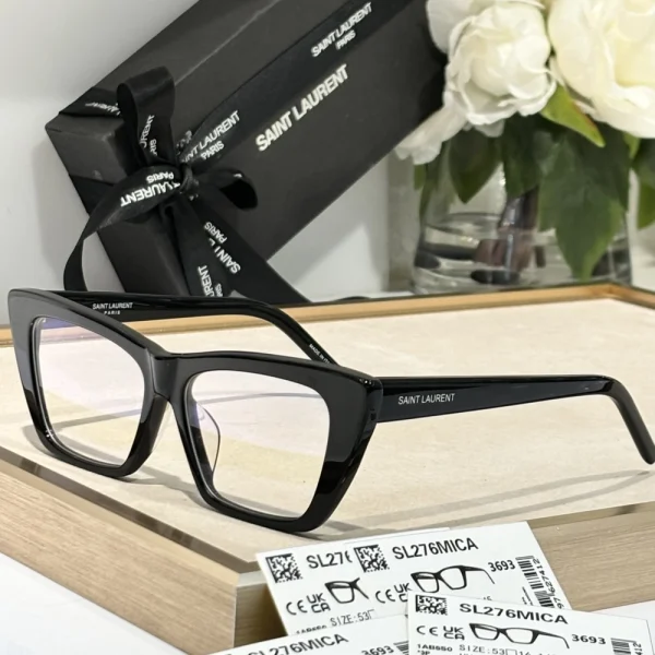 Elegant SL 276 Mica sunglasses by Saint Laurent resting on a white marble surface with branded case nearby