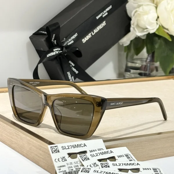 Saint Laurent SL 276 Mica sunglasses displayed flat on soft beige fabric, emphasizing refined silhouette
