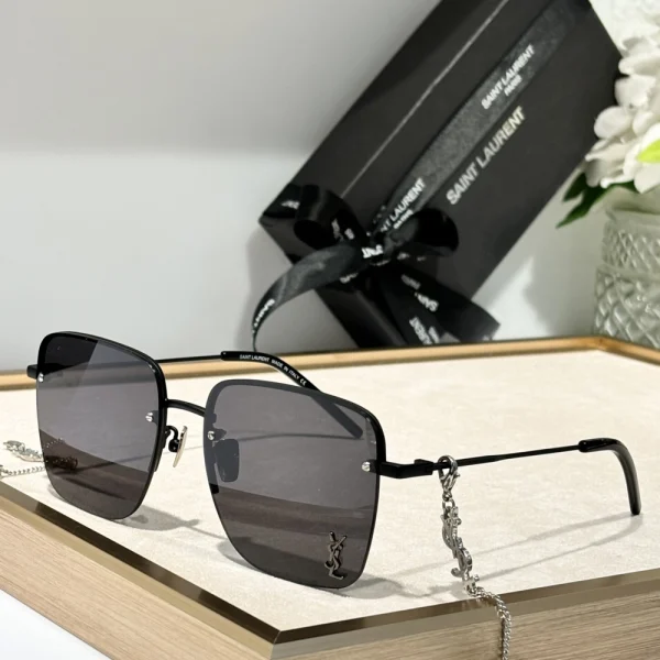 Close-up of Saint Laurent SL 312 M sunglasses highlighting refined temples and engraved silver logo