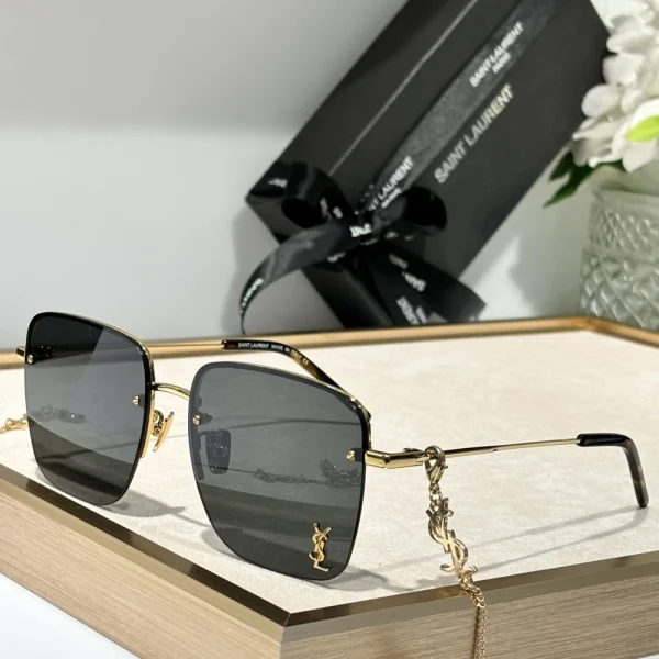 Black Saint Laurent SL 312 M sunglasses styled with neutral fashion accessories for a timeless look