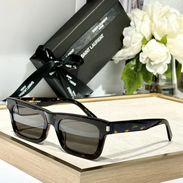 High-fashion Saint Laurent SL 461 Betty sunglasses under soft natural lighting, capturing glossy frame texture