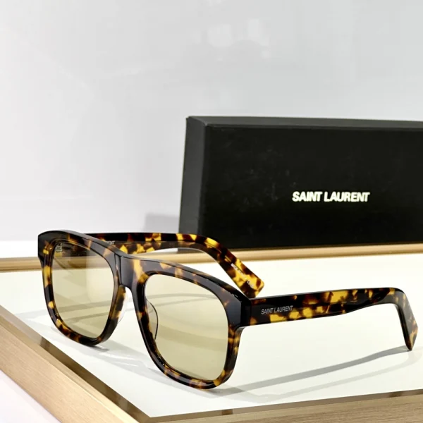 High-fashion Saint Laurent SL 558 sunglasses styled with minimalist accessories for a chic modern look