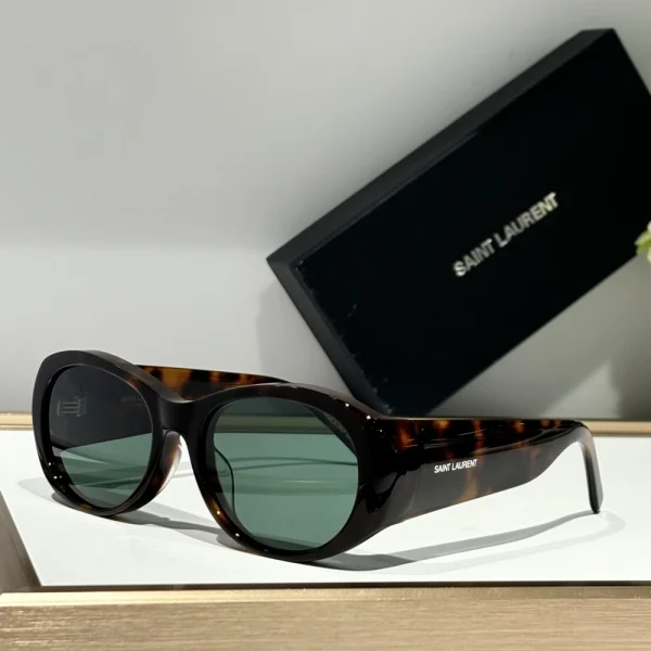 Saint Laurent SL 736 sunglasses in glossy black finish, featuring a bold rectangular frame and dark tinted lenses