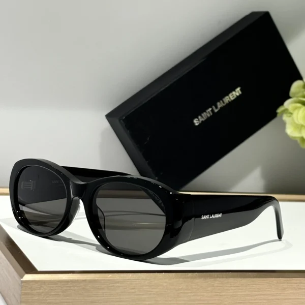 Saint Laurent SL 736 sunglasses placed beside fashion magazine, reflecting effortless Parisian cool