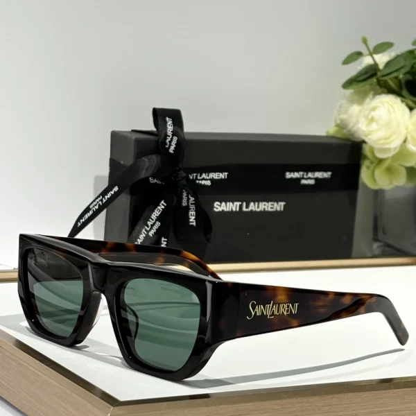 Close-up of Saint Laurent SL 740 sunglasses highlighting silver logo detail on sleek acetate temples