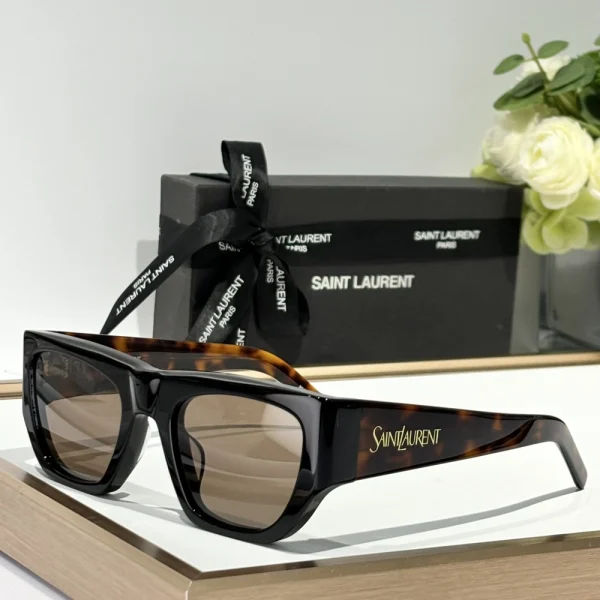 Front-facing Saint Laurent SL 740 sunglasses showcasing sharp rectangular silhouette and glossy finish