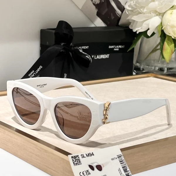 Saint Laurent SL M94 sunglasses with bold temples and refined details, photographed in natural daylight