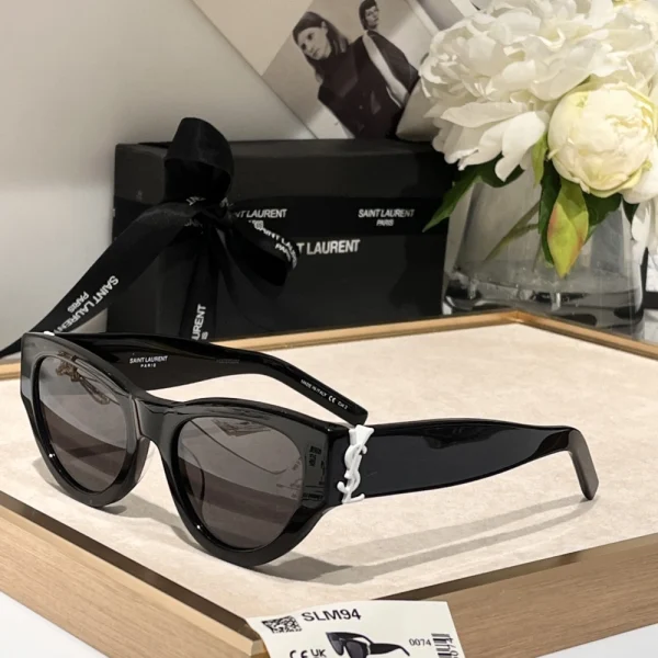 Elegant SL M94 sunglasses by Saint Laurent placed beside branded case and cleaning cloth