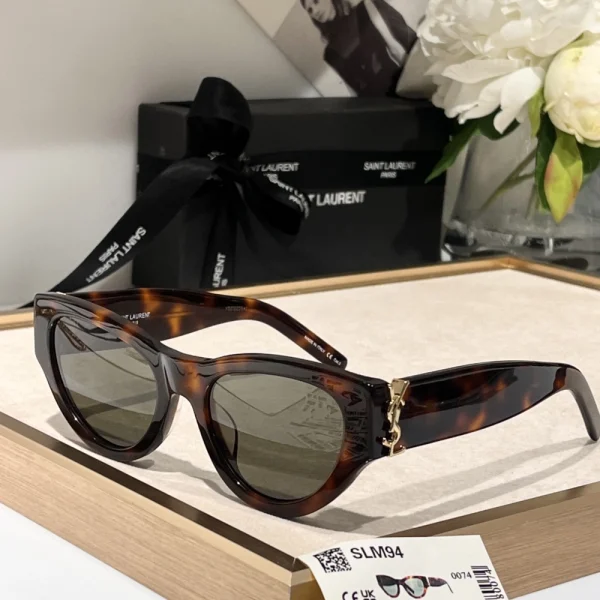 High-fashion Saint Laurent SL M94 sunglasses resting on marble surface under soft lighting