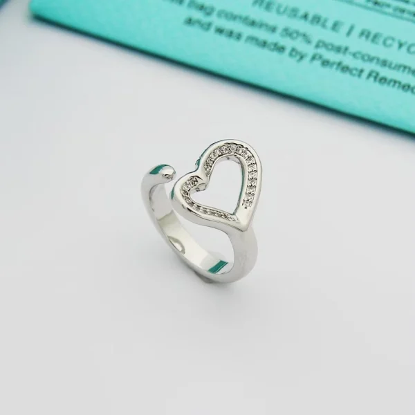 Close-up of Elsa Peretti Open Heart Ring showcasing delicate pavé diamonds and polished platinum band