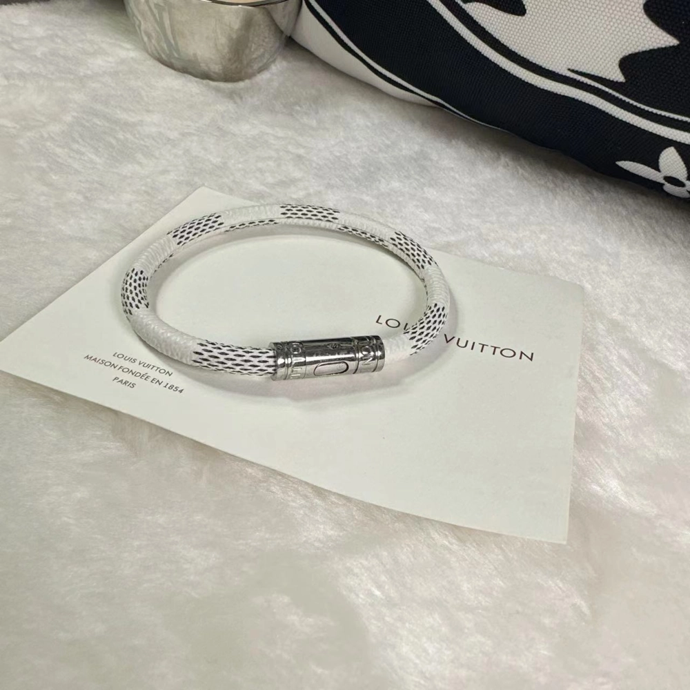 Louis Vuitton Keep It Bracelet featuring signature LV monogram strap and polished metal clasp