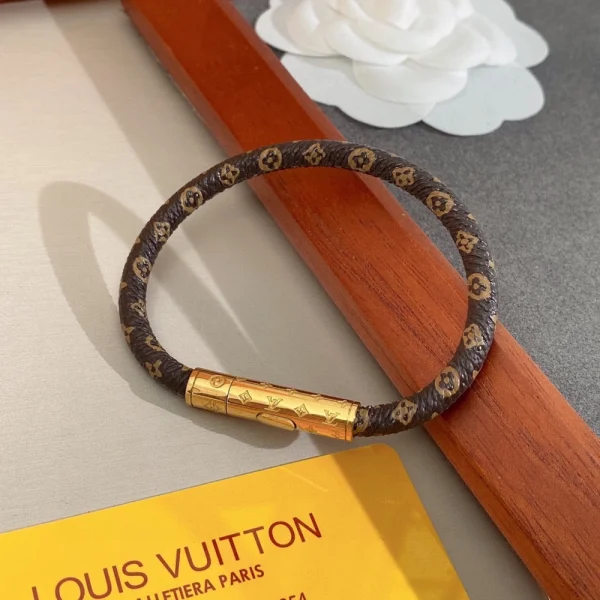 Detailed shot of Louis Vuitton LV Bracelet showing the engraved LV emblem and smooth link design