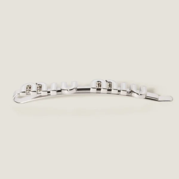 Miu Miu enameled metal hair clip displayed on neutral background emphasizing craftsmanship