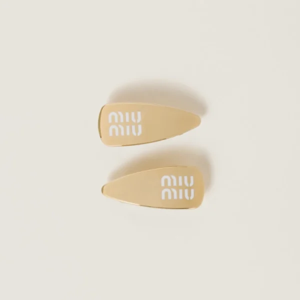Set of Miu Miu enameled metal hair clips featuring glossy finish and signature engraved logo