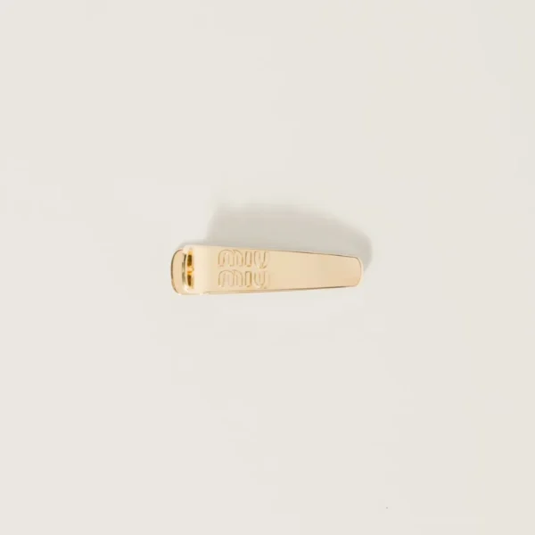 Miu Miu metal hair clip featuring polished metal finish and engraved logo detail