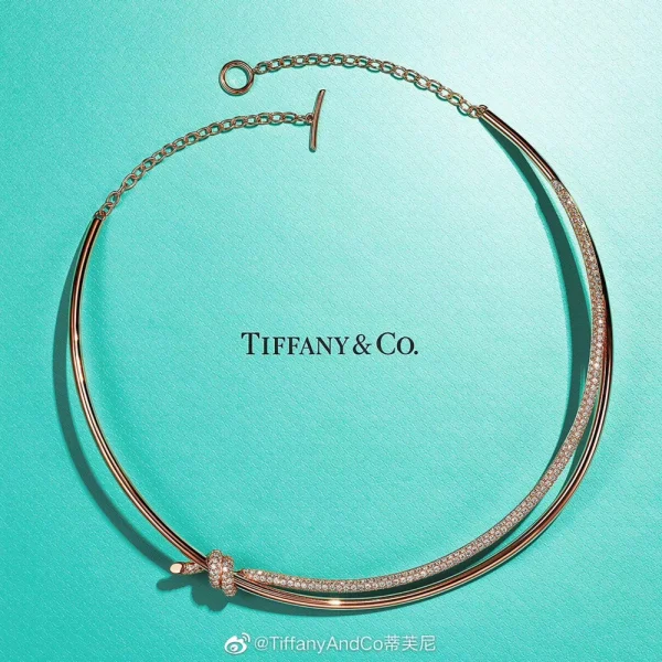 Side angle of the Double Row Necklace showing interwoven knot motif and polished rose gold finish