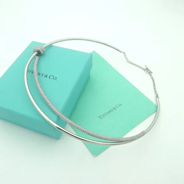 Close-up of Tiffany Knot Necklace in white gold with two rows and shimmering pavé diamond knot