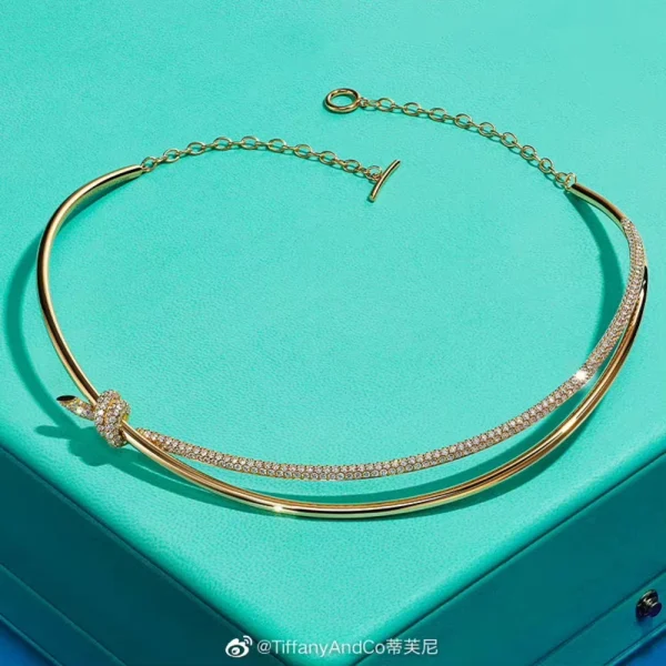 Tiffany Double Row Necklace displayed flat, featuring dual chain rows and a pavé diamond knot centerpiece